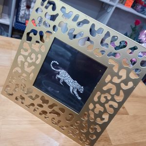 a square gold metal frame in a leopard print design