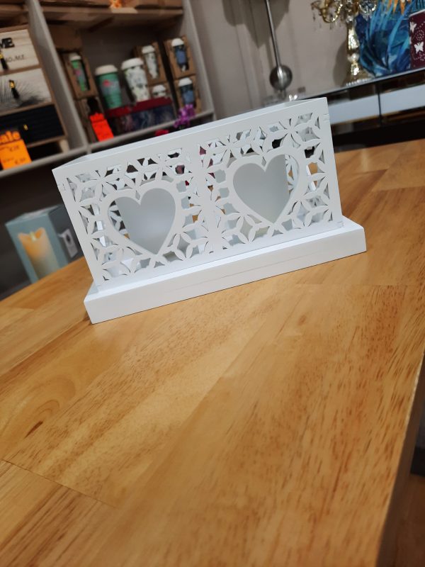 white wooden candle holder with 2 heart shaped cut outs