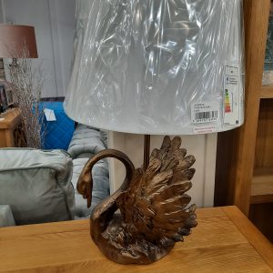 a copper coloured swan lamp with a white shade