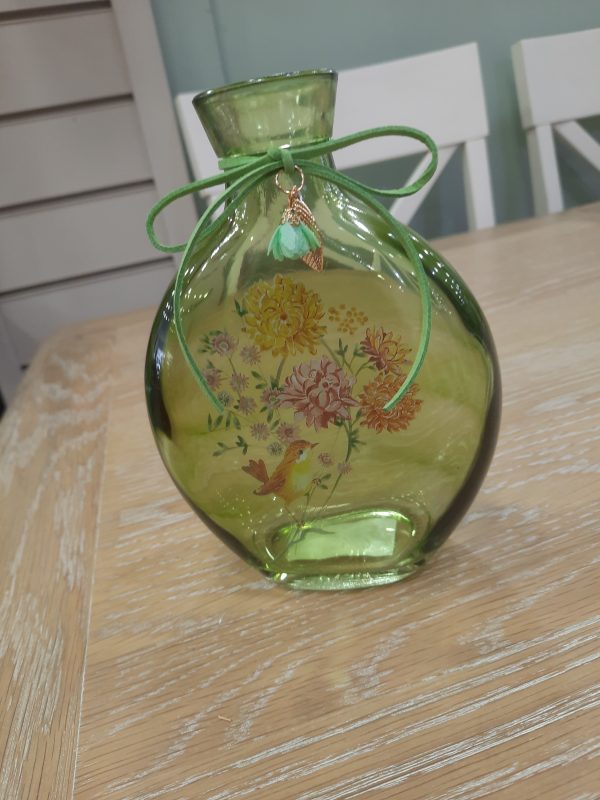 a green westport glass bottle vase with a floral design