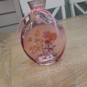 a pink westport glass bottle vase with a floral design