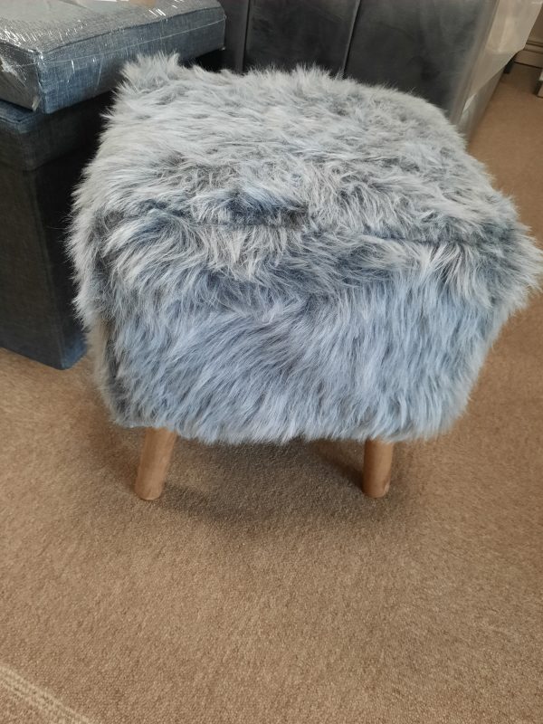 an image of a grey faux fur footstool