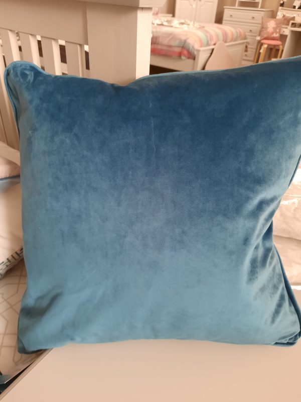 an image of a teal velvet cushion
