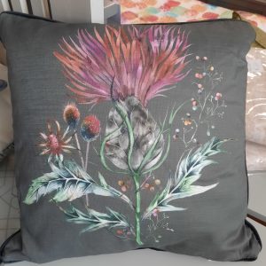 an image of a floral cushion on a dark grey background