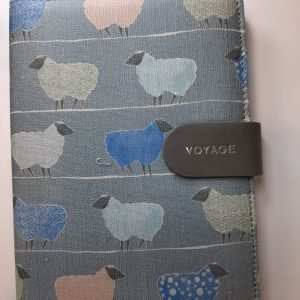 an image of a fabric notebook with blue sheep on it
