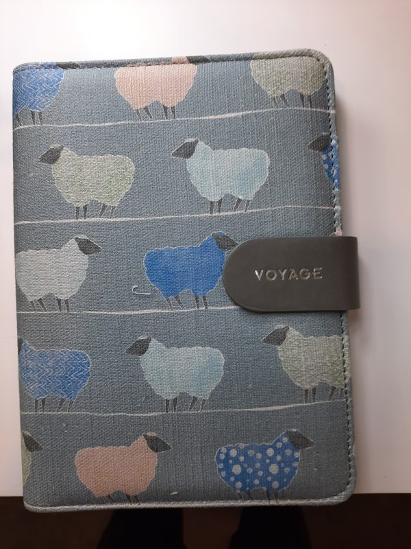 an image of a fabric notebook with blue sheep on it