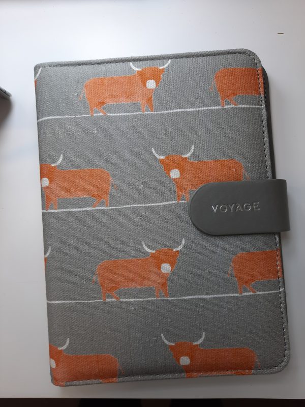 an image of a fabric notebook with orange bulls on it