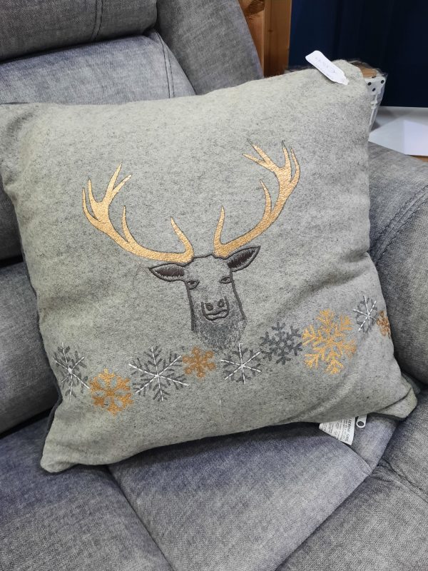 an image of a grey cushion with a gold reindeer on it